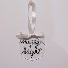 Load image into Gallery viewer, Each clear acrylic ornament is a flat 4 inch round that can be personalized with a name or small phrase.  This classic style comes in your choice of ribbon and font colour. If you would like your ornament to also have the background painted please let me know the colour below.   4 inch round, 4mm thickness.
