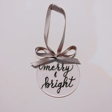 Load image into Gallery viewer, Each clear acrylic ornament is a flat 4 inch round that can be personalized with a name or small phrase. This classic style comes in your choice of ribbon and font colour. If you would like your ornament to also have the background painted please let me know the colour below. 4 inch round, 4mm thickness.