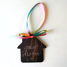 Load image into Gallery viewer, Have you bought a new home this year or are you looking for a personalized gift for someone who bought a new home this year? These ornaments are the perfect gift for the new homeowner in your life, a special ornament to remember the occasion. Each personalized Christmas house ornaments each comes in your choice of stain, font and ribbon colour. Each handmade ornament can have a name or small quote written in calligraphy with the year.
