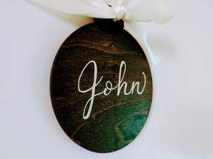 Each holiday wood ornaments is stained your choice of colour, and can be personalized with a name or small phrase in your choice of font colour.  Each ornament has a ribbon tied in a bow that is included.  Baltic Birch 4 inch round, 3mm thick.
