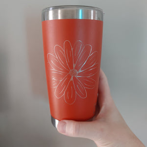 Orange Yeti drinkware engraved with a floral of a daisy