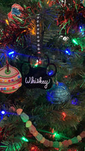 Load image into Gallery viewer, This Christmas ornament is a black paw ornament with white calligraphy font on a Christmas tree. It is the perfect gift for the pet owner in your life 

