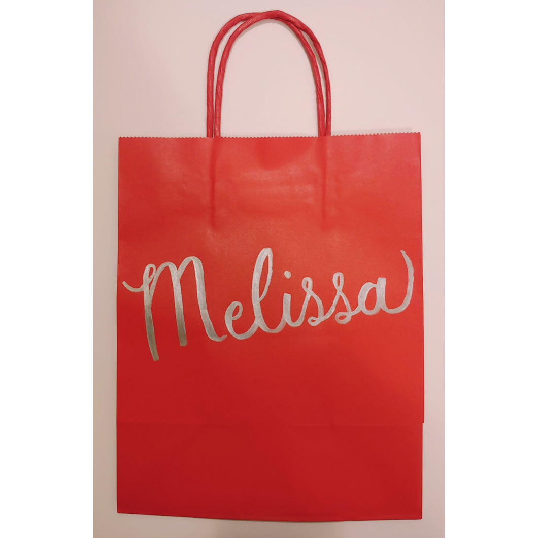 This red gift bag is personalized with the name or wording of your choice. Each bag is written any calligraphy in your choice of font colour.  Medium kraft bag dimensions: 8 x 10 inches (20.3cm x 25.4 cm)