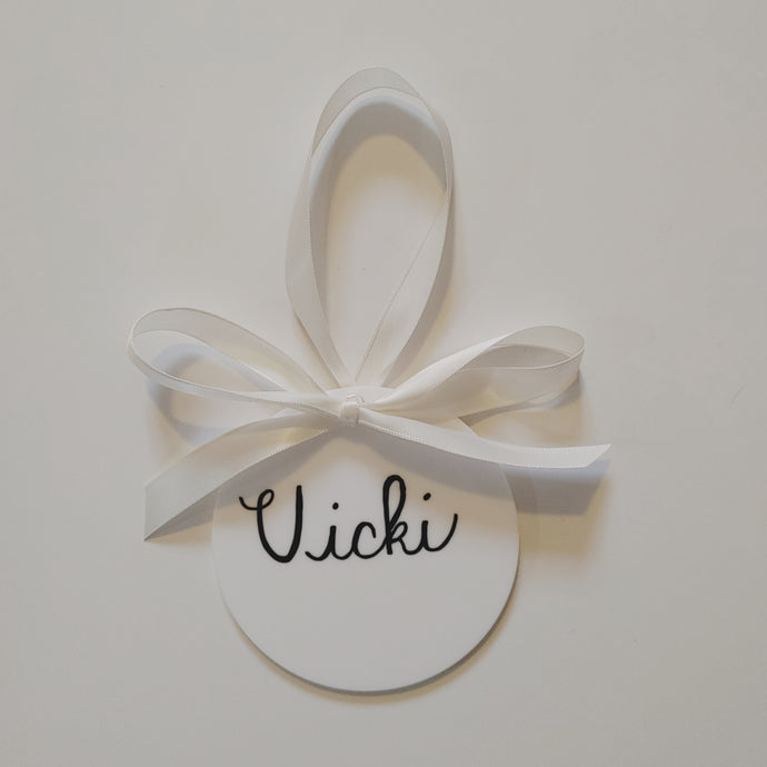 Each white acrylic ornament is a flat 4 inch round that can be personalized with a name or small phrase. This perfect classic style comes in your choice of ribbon and font colour.   4 inch round, 4mm thickness.