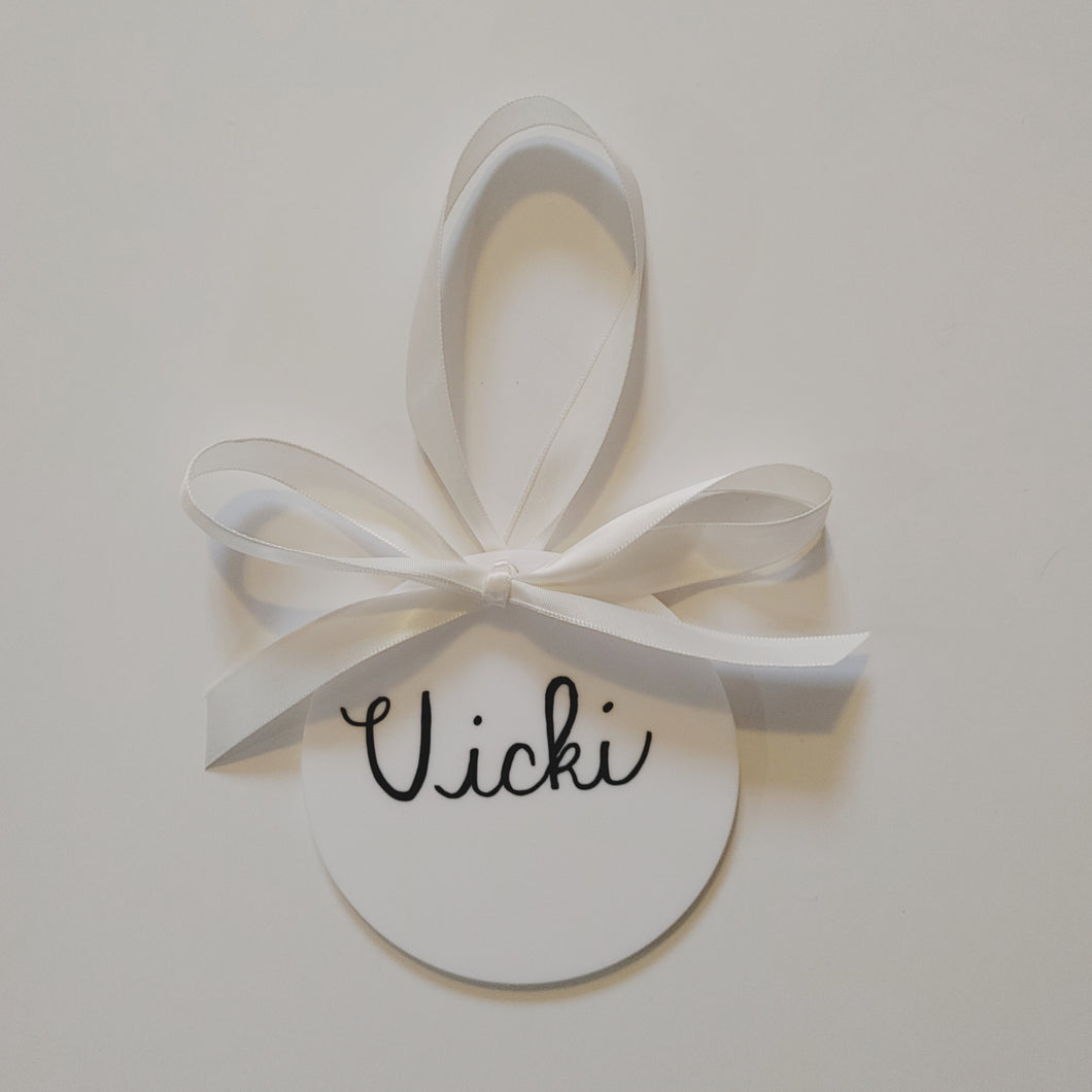 Each white acrylic ornament is a flat 4 inch round that can be personalized with a name or small phrase. This perfect classic style comes in your choice of ribbon and font colour.   4 inch round, 4mm thickness.