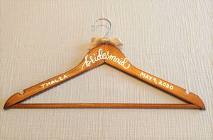 If you are looking for a perfect gift for your bridesmaid here is a custom hanger to accent her beautiful dress.  Wood hangers are hand-lettered with the bridesmaid's name and the wedding date. "bridesmaid" is written in calligraphy on the centre of the hanger, and the bridesmaid's name and your wedding date in block lettering with your choice of gold or chrome font colour.